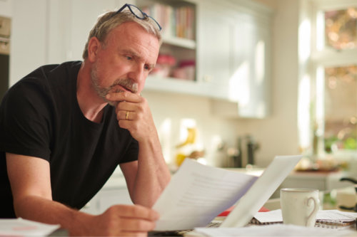 A man looks at a bill